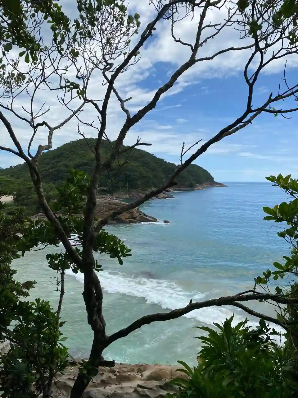 Vista do mirante na trilha do Caxadaço em Trindade, Paraty, com mar azul e vegetação de mata atlântica