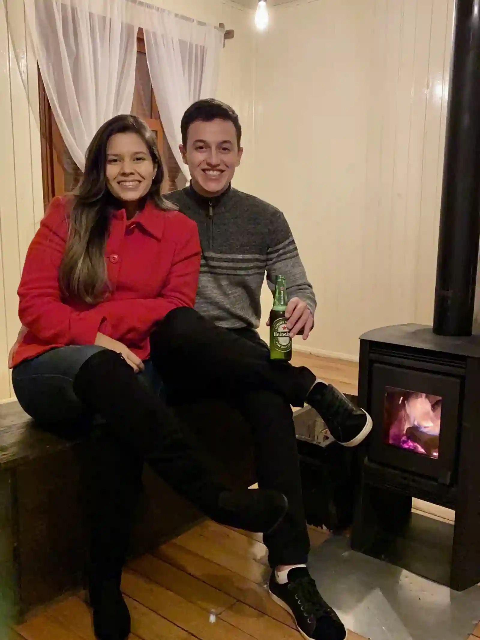 Casal aquecendo-se na lareira de chalé em Cambará do Sul